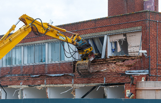 demolition-excavator-arm-tearing-down-brick-buildi-2026-09-22-21-47-49-utc